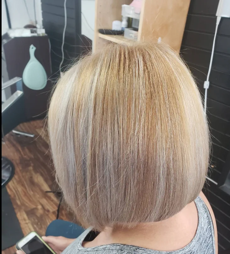 Sleek blonde bob with a smooth blowout finish.